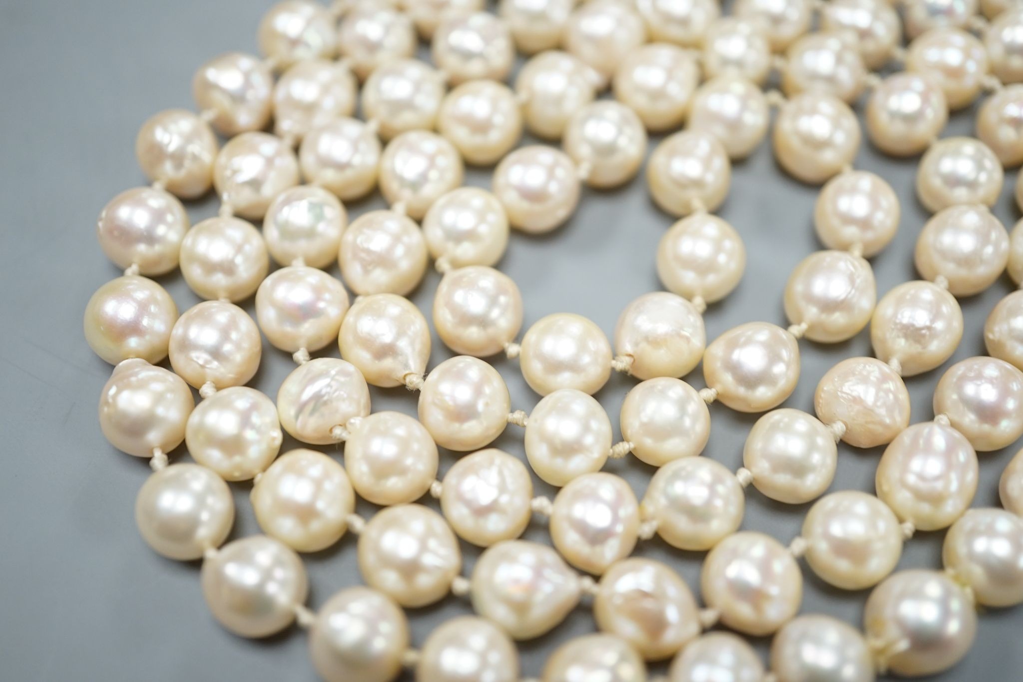 A long single strand baroque cultured pearl necklace, 128cm.